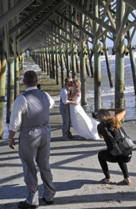 Beach wedding under pier